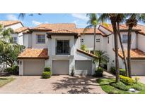Charming townhomes with tile roofs, paved driveways, and attached two-car garages at 1117 Shipwatch Cir, Tampa, FL 33602