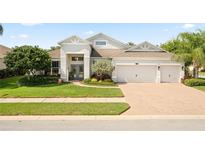 Charming single-story home featuring a three-car garage, well-manicured lawn, and beautiful landscaping at 13135 Plantation Ter, Seminole, FL 33776