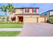 Charming two-story home featuring a three-car garage and brick-paved driveway at 19533 Whispering Brook Dr, Tampa, FL 33647