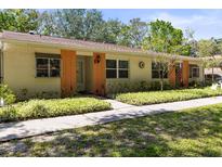Charming one-story home with a well-maintained lawn and cozy front porch at 2212 Lark W Cir # E, Palm Harbor, FL 34684