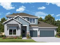 Charming two-story home with a two car garage, stone accents, landscaped yard and covered entry at 31418 Hayman Loop, Wesley Chapel, FL 33545