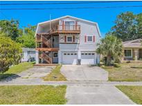 Charming two-story home featuring a unique double-deck design and two-car garage at 503 Chestnut St, Oldsmar, FL 34677