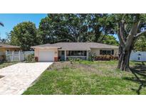 Charming ranch-style home with a brick driveway and mature trees offering shade at 5072 98Th Way, St Petersburg, FL 33708