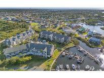 Aerial view of condos, private docks and marina in a waterfront community near the intercoastal waterway at 5537 Sea Forest Dr # 304, New Port Richey, FL 34652