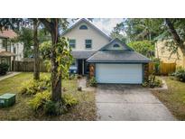 Charming home featuring lush landscaping, a two-car garage, and a beautifully maintained front yard at 678 Greenglen Ln, Palm Harbor, FL 34684