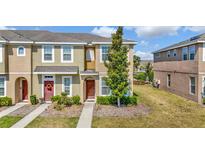 Attractive two-story townhouse with manicured lawn and inviting entrance at 7021 White Treetop Pl, Riverview, FL 33578