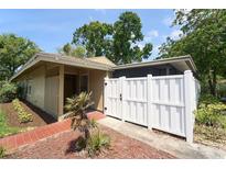 Inviting home featuring a private white-fenced courtyard and lush landscaping around the house at 7205 San Luis Ct, Tampa, FL 33634
