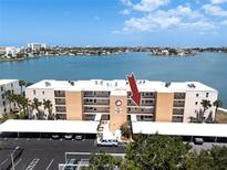 Exterior of condominium complex, The Yorktown, with covered parking and waterfront views in a sunny location at 7910 Sun Island S Dr # 203, South Pasadena, FL 33707
