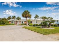 Beautiful single story home with a circular driveway and tropical landscaping at 8727 Bay Crest Ln, Tampa, FL 33615