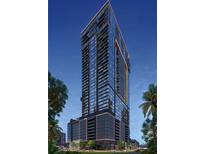 Stunning exterior elevation of a modern high-rise building with sleek lines and a beautiful blue hour sky at 1101 E Jackson St # 2008, Tampa, FL 33602