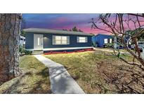 Charming single-story home featuring a blue exterior, white trim, and well-maintained landscaping at 1402 Freemont S St, Gulfport, FL 33707