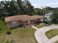 A charming single-story home with a covered porch and attached garage, surrounded by lush landscaping at 1710 26Th S Ave, St Petersburg, FL 33712