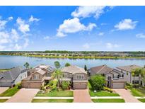 Waterfront homes boast manicured lawns and stunning lake views in this beautiful community at 1830 Nature View Dr, Lutz, FL 33558