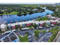 Aerial view of waterfront condo community, with private docks, boat slips, covered parking, and city views at 2424 W Tampa Bay Blvd # I202, Tampa, FL 33607