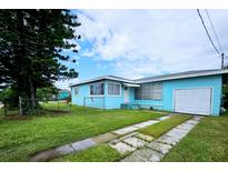 Charming single-story home with a well-maintained lawn and an attached single-car garage at 300 144Th Ave, Madeira Beach, FL 33708