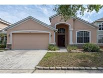 Charming single-Gathering home with a well-manicured lawn and two-car garage at 416 Durham Shore Ct, Apollo Beach, FL 33572