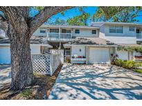 Inviting townhouse featuring a well-manicured lawn, attached garage, and lovely curb appeal, perfect for relaxed living at 5115 S Jules Verne Ct, Tampa, FL 33611