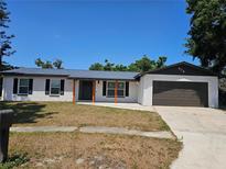 Charming one-story home with a painted brick exterior, black shutters, and a well-manicured lawn at 906 Mate Pl, Seffner, FL 33584