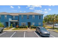 Bright two-story townhome with manicured landscaping and parking in front at 12805 Kings Crossing Dr, Gibsonton, FL 33534