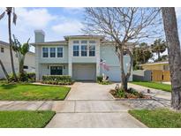 Charming two-story home with a well-manicured lawn and an American flag proudly displayed at 1842 Bayou Grande Ne Blvd, St Petersburg, FL 33703