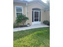 Charming front entrance with a screened door, mature landscaping, and neutral exterior at 2007 Acadia Greens Dr # 0, Sun City Center, FL 33573
