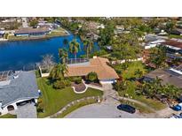 Stunning waterfront home with mature landscaping, private dock, and lovely curb appeal at 2142 Ibis, Clearwater, FL 33764