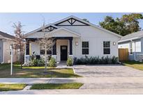Charming home with a well-manicured lawn, stylish black and white accents, and a welcoming front entrance at 2150 43Rd N Ter, St Petersburg, FL 33714