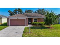 Charming single-story home with a well-manicured lawn and attached two-car garage at 3212 55Th E St, Palmetto, FL 34221