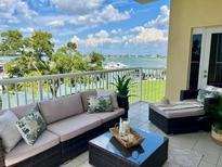 Relaxing waterfront balcony featuring a cozy seating area with views of the harbor at 425 150Th Ave # 2301, Madeira Beach, FL 33708