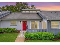 Charming single-story home featuring a red door with wreath and a well-maintained front lawn at 50 Balsam Dr, Oldsmar, FL 34677