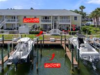 Waterfront condo building with private boat dock featuring multiple boats and waterfront views at 5174 Beach Se Dr # B, St Petersburg, FL 33705
