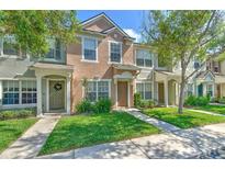 Charming townhome with manicured lawn and inviting entryway with lush green landscaping at 10106 Bessemer Pond Ct, Riverview, FL 33578