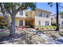 Charming two-story townhome with well-manicured landscaping and inviting walkway at 10928 Brickside Ct, Riverview, FL 33579