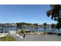 Stunning waterfront view from the deck showcasing the serene water and neighborhood homes along the water's edge at 1108 W Virginia Ave, Tampa, FL 33603