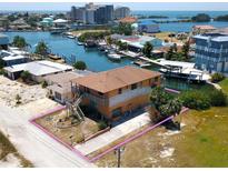 Waterfront two-story home featuring a spacious lot, long driveway, and beautiful water access at 13931 Hatcher Ave, Hudson, FL 34667