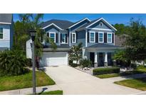 Beautiful two-story home with a manicured lawn, a two car garage, and elegant landscaping at 14975 Renaissance Ave, Odessa, FL 33556