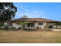 Charming single-story home featuring a well-kept yard and a convenient carport at 3515 Bell Farms Dr, Plant City, FL 33566