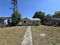 Traditional single story home with small front porch, walkway and lawn at 4420 6Th S Ave, St Petersburg, FL 33711