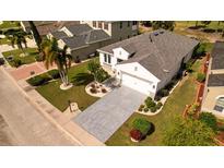 An aerial view of a meticulously maintained single-Gathering home with a lush lawn and elegant landscaping at 443 Noble Faire Dr, Sun City Center, FL 33573