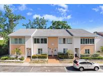 Inviting two-story townhouse featuring a well-maintained facade, manicured landscaping, and ample parking at 563 99Th N Ave # 102, St Petersburg, FL 33702