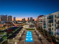 Rooftop pool with city skyline views at dusk at 1120 E Kennedy Blvd # 1228, Tampa, FL 33602
