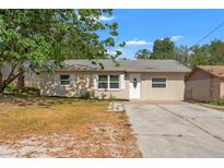 Charming single-story home featuring a well-manicured lawn and a private driveway at 15124 Omaha St, Hudson, FL 34667