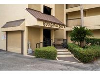 Welcoming entrance to 1800 Golfview Drive with well-manicured landscaping, convenient seating, and ample parking at 1817 Golfview Dr # 1817, Tarpon Springs, FL 34689
