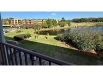 Overlooking the backyard with a peaceful pond view from the balcony at 225 Country Club Dr # A207, Largo, FL 33771