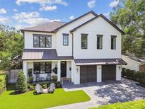 Stunning two-story home featuring a welcoming front porch and an attached two-car garage at 2402 W Parkland Blvd, Tampa, FL 33609