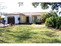 Charming single-story home with a well-maintained lawn, inviting curb appeal, and an attached garage at 2460 Beacon Groves Blvd, Palm Harbor, FL 34683
