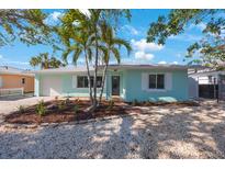 Charming light blue single-story home with tidy landscaping, new windows, and a one car garage at 280 41St Ave, St Pete Beach, FL 33706
