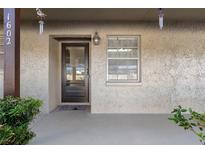 Charming front entryway featuring a secure door and a welcoming, covered porch area at 601 N Hercules Ave # 1602, Clearwater, FL 33765