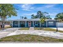 Charming single-story home with a well-manicured lawn and inviting curb appeal, front-facing view on a sunny day at 6511 Georgia Ave, Bradenton, FL 34207