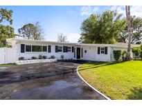 Charming single story home featuring a well-maintained lawn and a freshly paved driveway at 722 61St S Ave, St Petersburg, FL 33705
